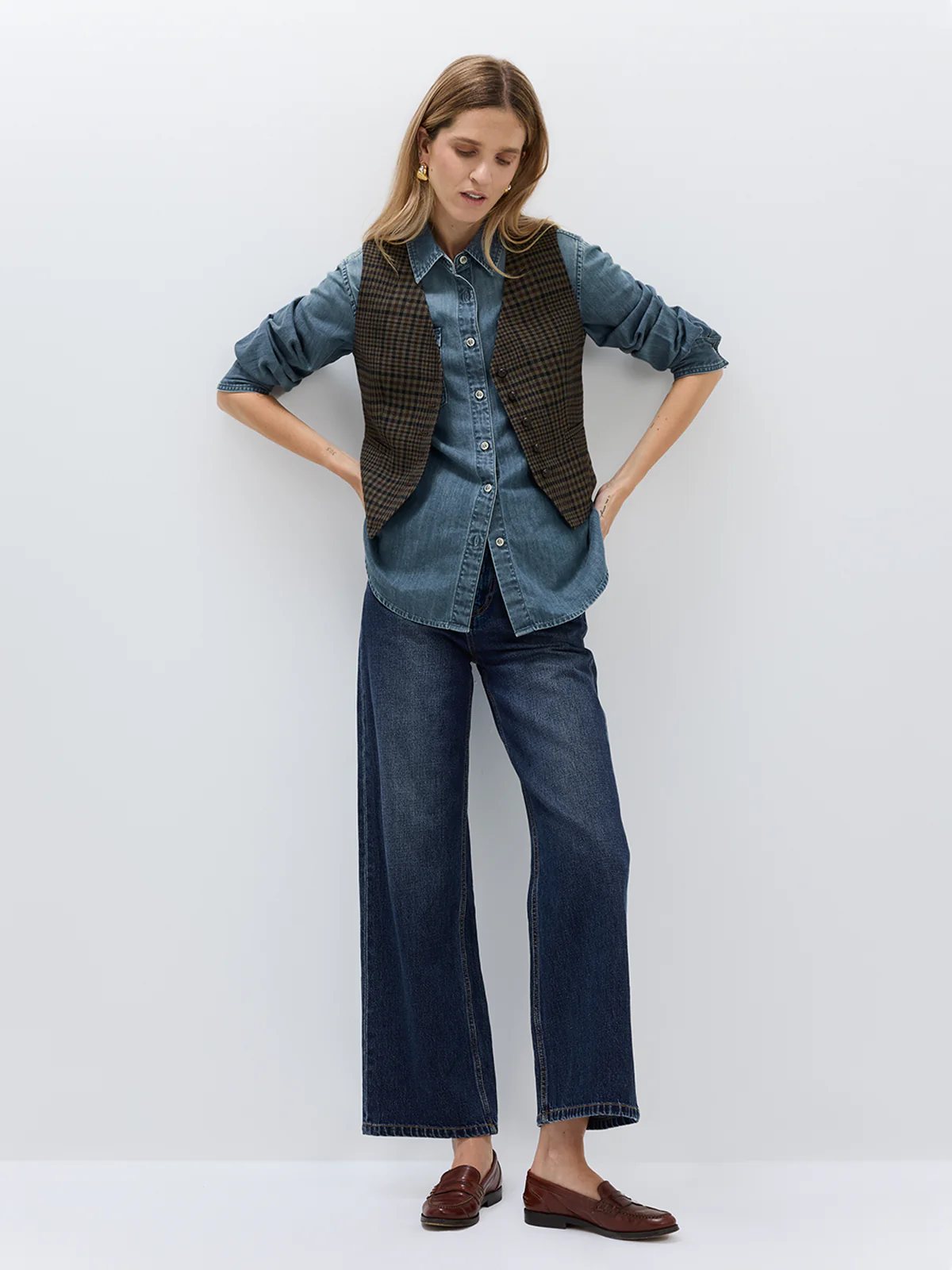 andreatang vintage brown check vest layered over denim shirt with wide-leg blue jeans and loafers