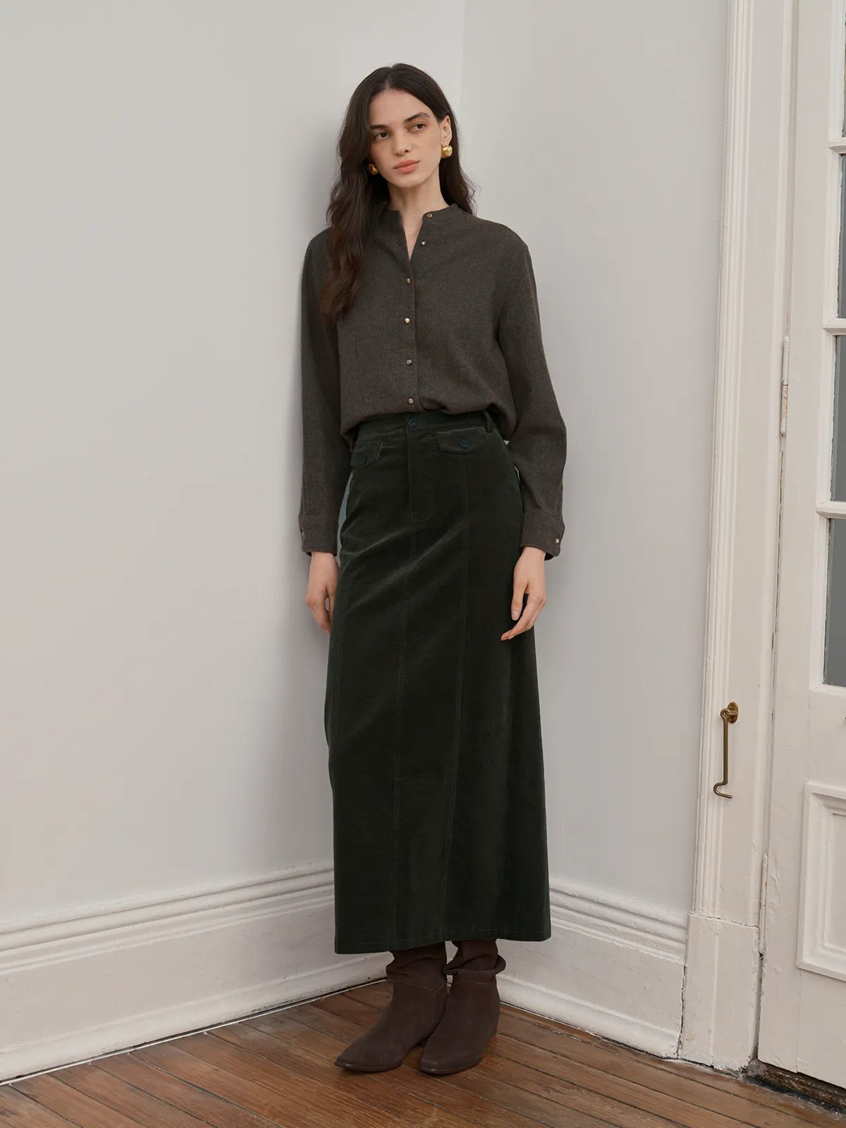 Model in WINSLOW shirt with dark green corduroy midi skirt and suede boots