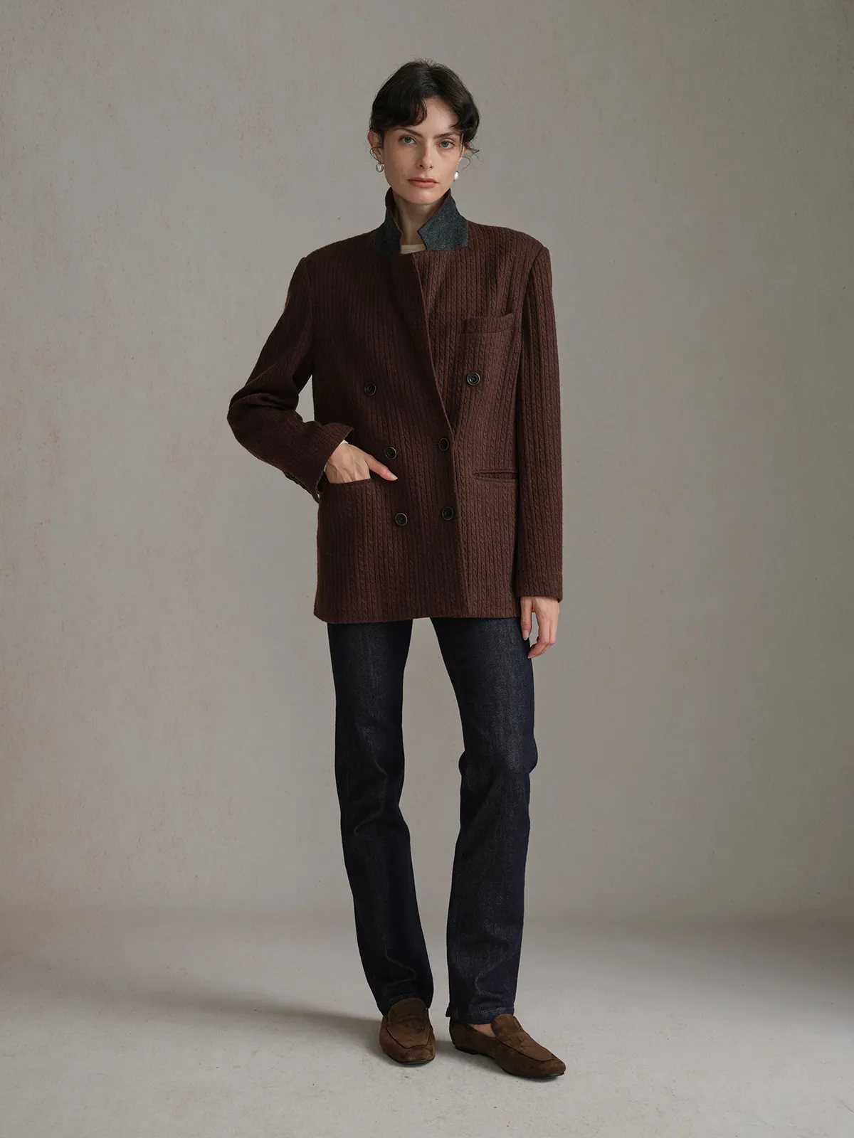 Model wearing warm chocolate HARLOW Cable Knit Blazer with contrasting grey collar, layered over olive tee and dark denim