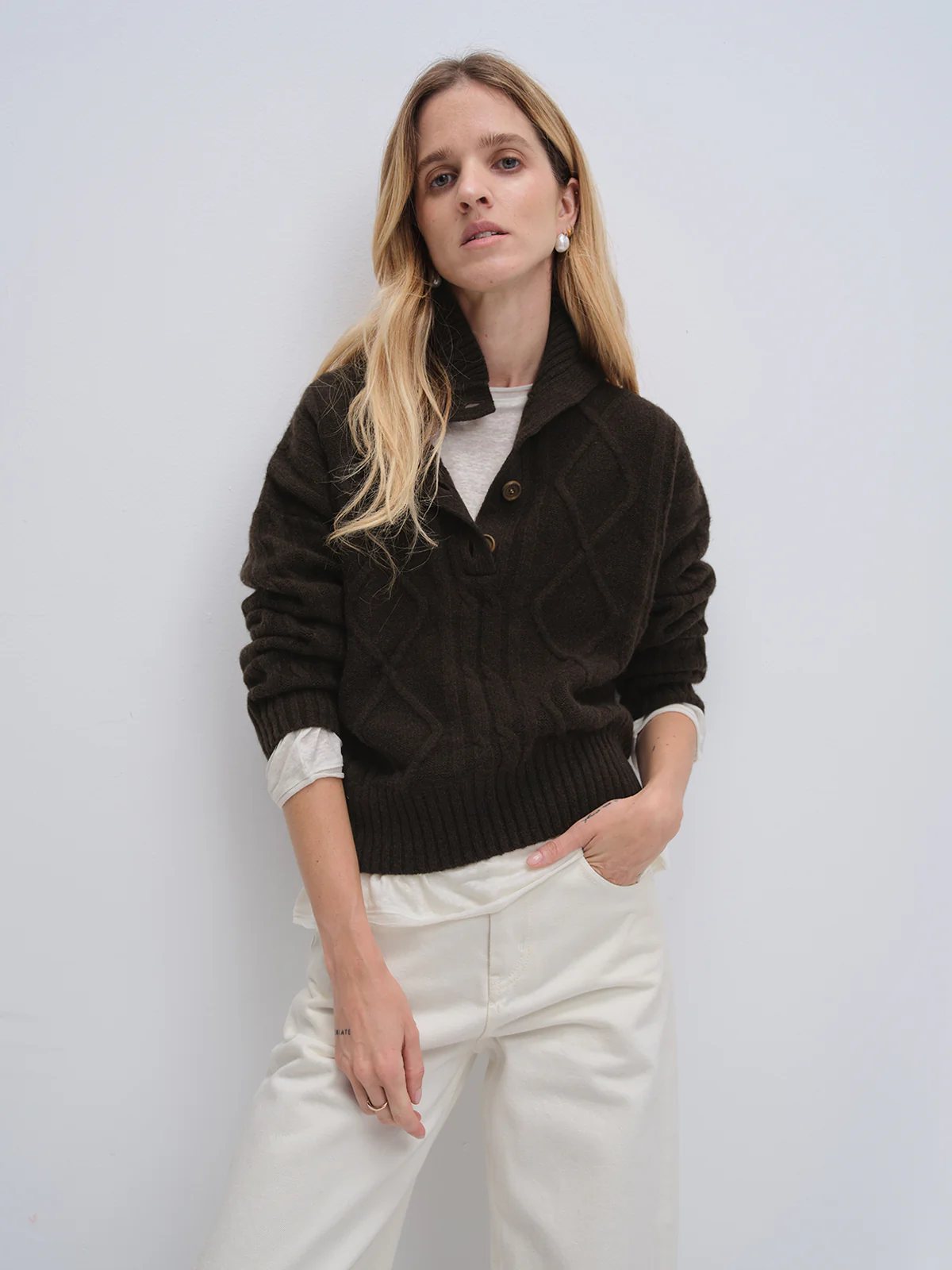 andreatang yak and wool buttoned collar sweater layered over T-shirt with white trousers