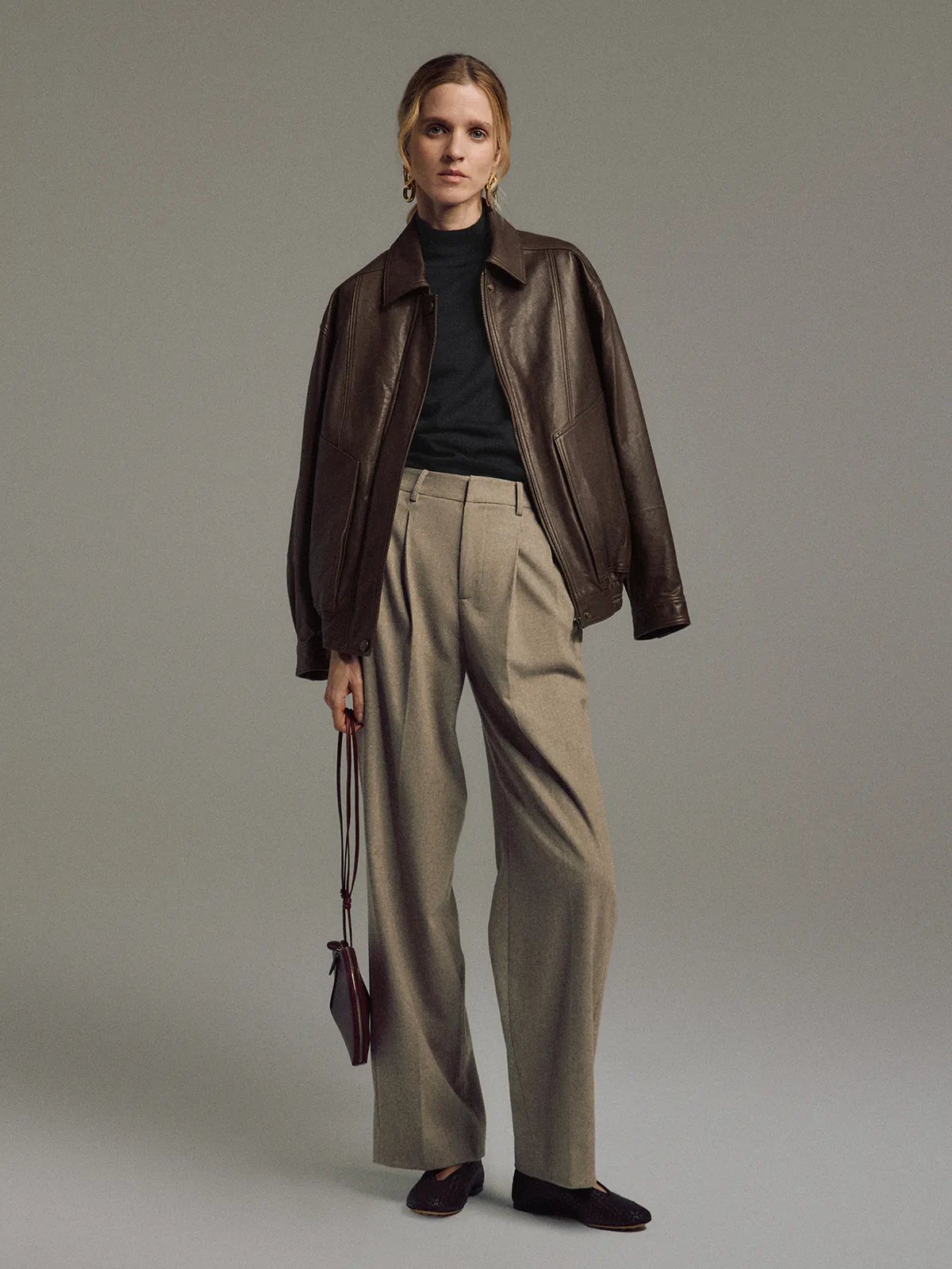 Model wearing a Dark Brown Italian shearling leather jacket with detachable lining, front view.
