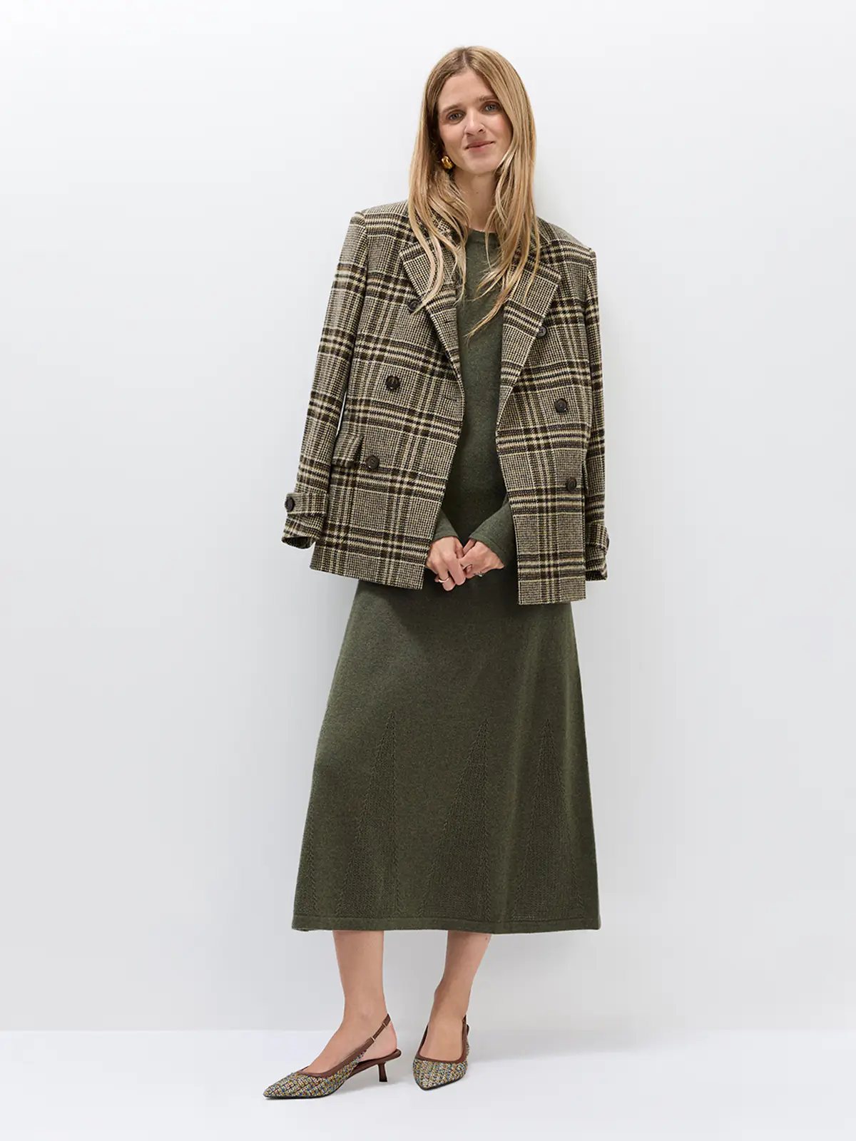 Model wearing the long-sleeve knitted dress layered under a matching cardigan, front view.