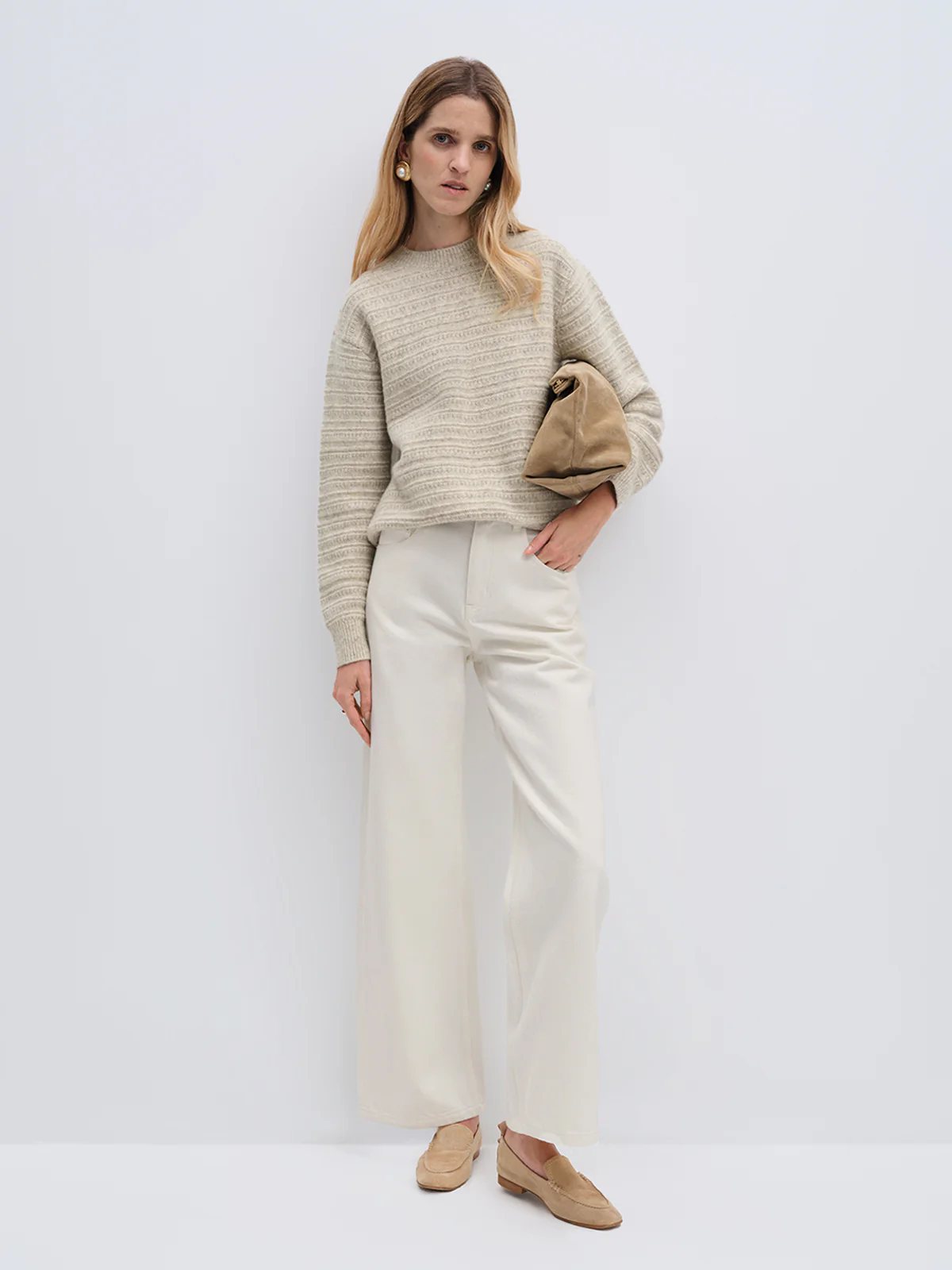Model in andreatang wool-cotton jacquard sweater, oatmeal/blue-grey stripes, styled with ivory pants and tan loafers