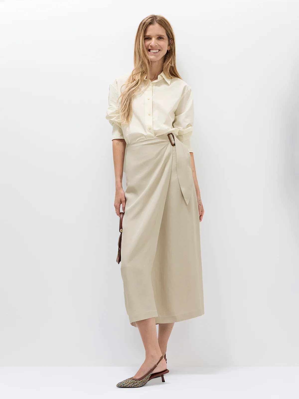 Close-up front view of the Oatmeal acetate wrap midi skirt showing drape and buckle detail.
