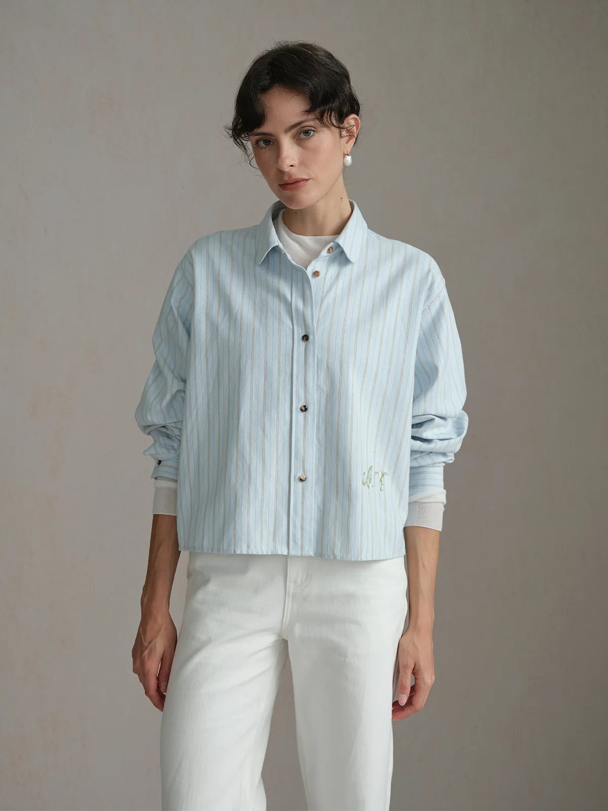 Front full-body view of model in PIXIE shirt, slightly angled pose, neutral backdrop, emphasizing relaxed fit