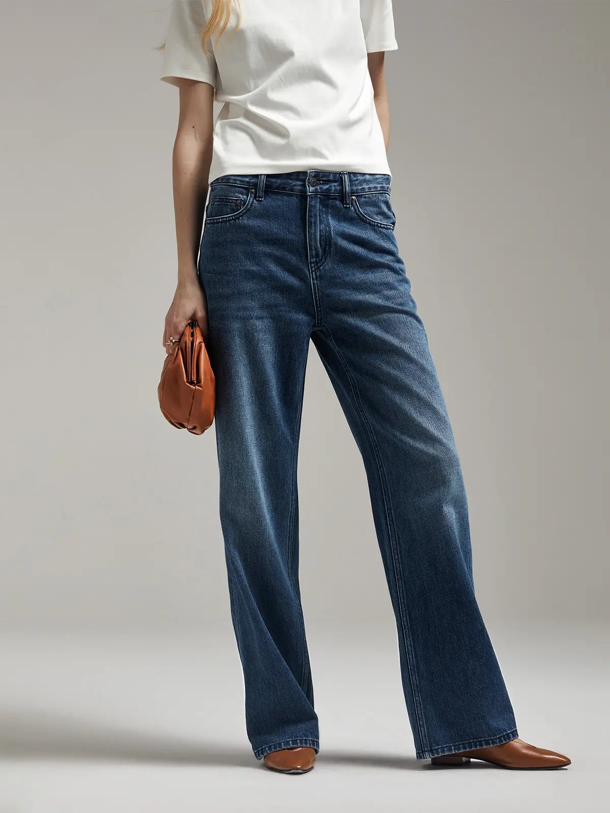 Front view of a model in Blue retro dark blue waist straight jeans with a button-up shirt and patterned flats.