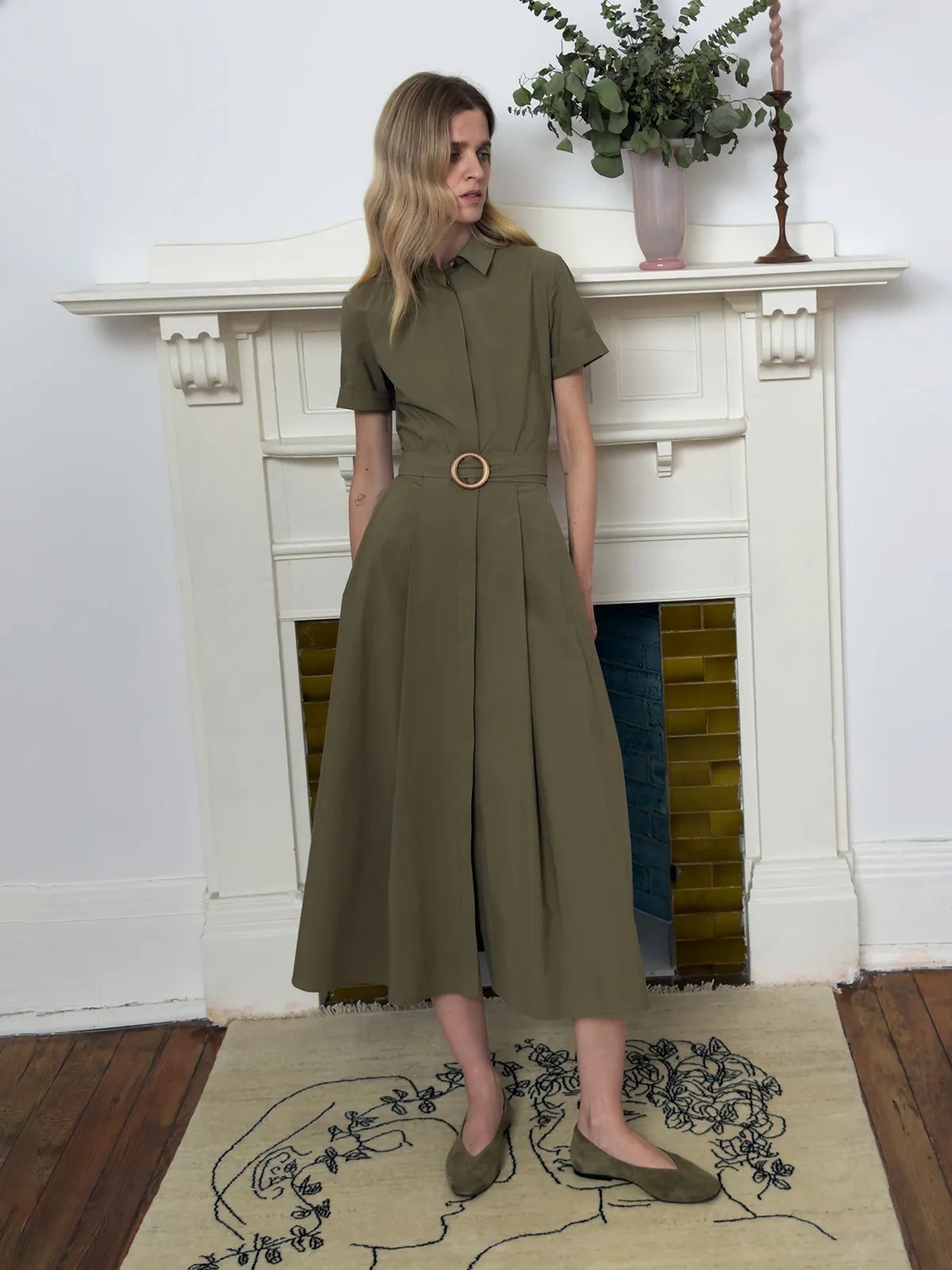 IMANI shirt dress front view with model looking sideways, relaxed posture on embroidered rug