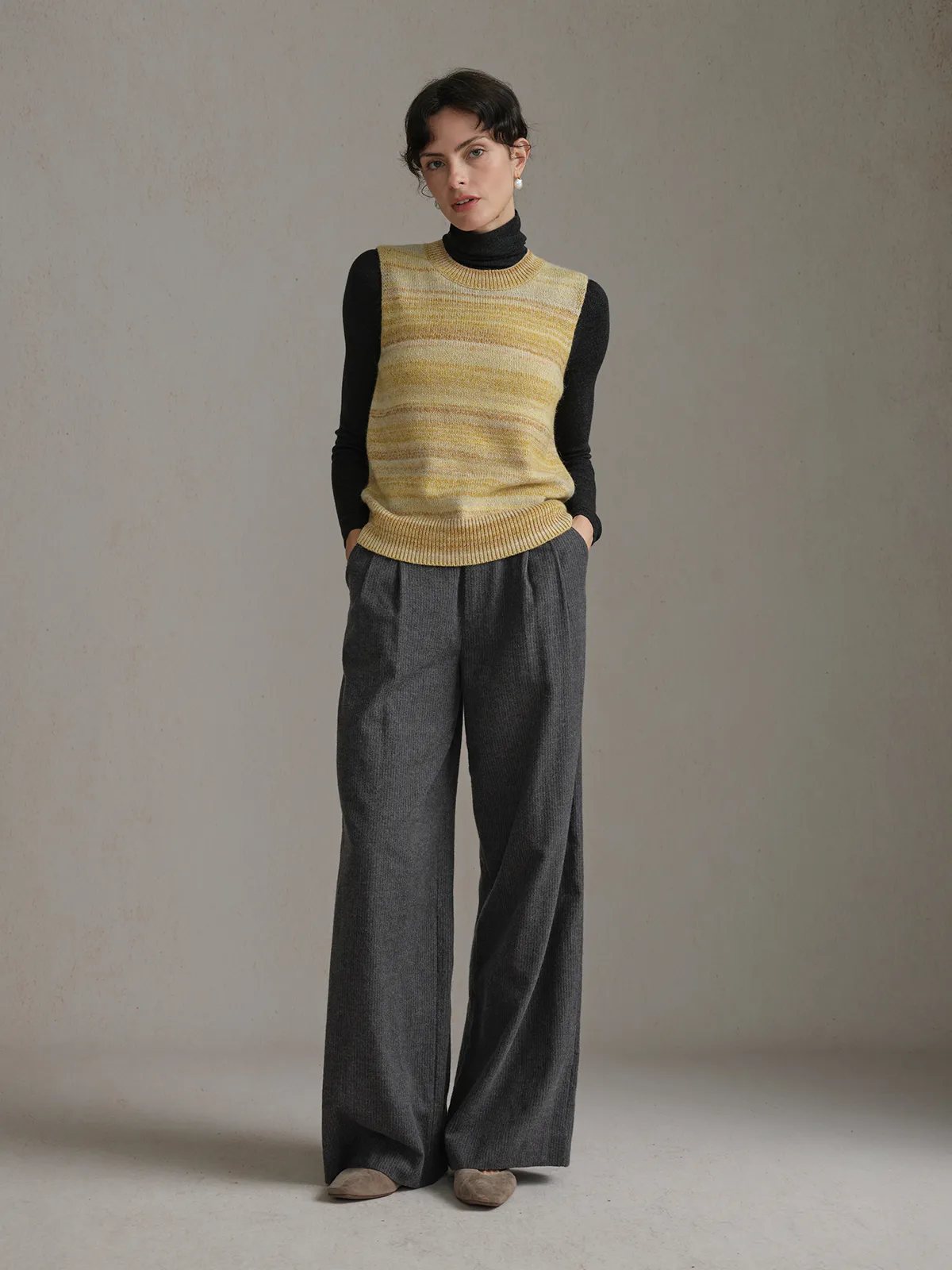 RIPPLE Gradient Stripe Knit Jumper over black turtleneck, grey trousers, hands in pockets—effortless chic