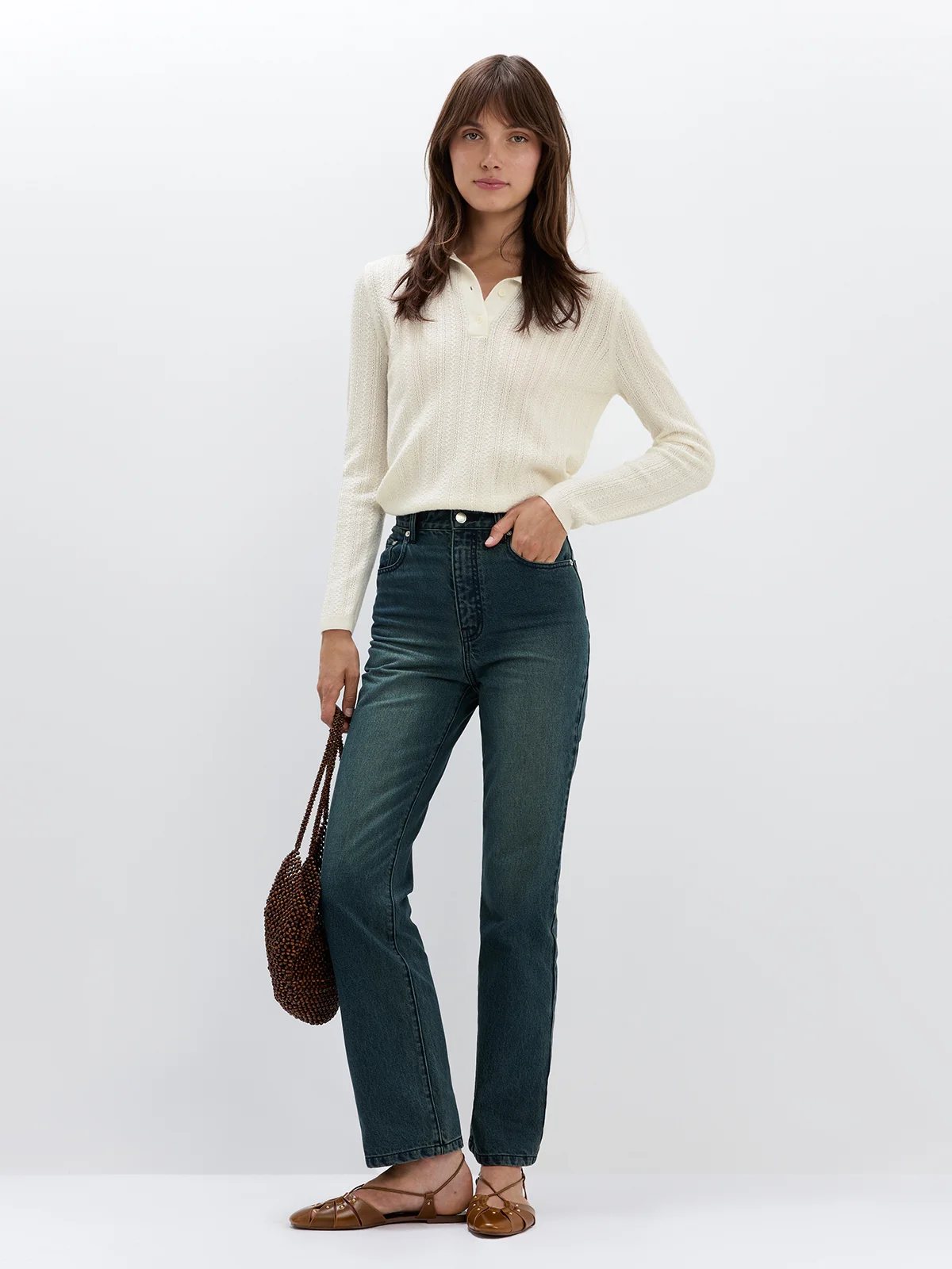 Model in Blue mid-rise slim straight jeans layered under a plaid blazer and shirt, styled with ankle boots.