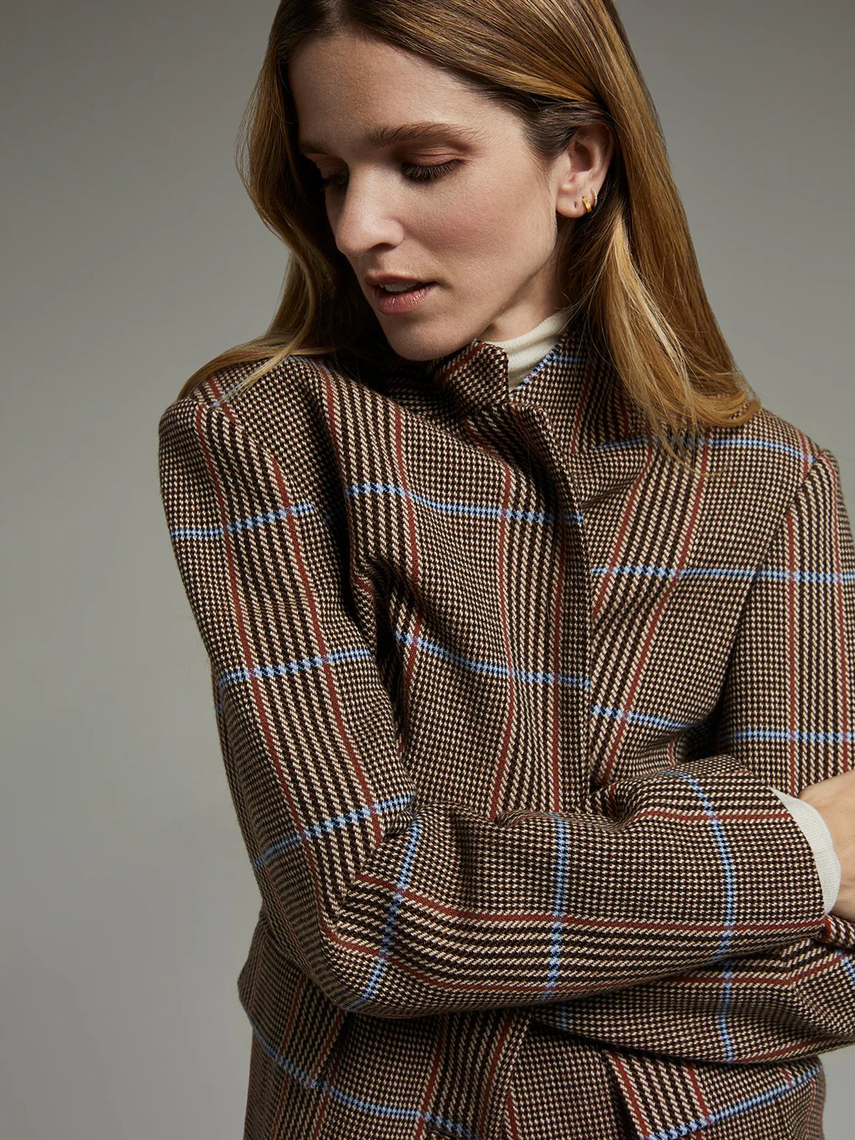 Close-up of andreatang wool tweed blazer showing oversized brown check with light-blue overcheck