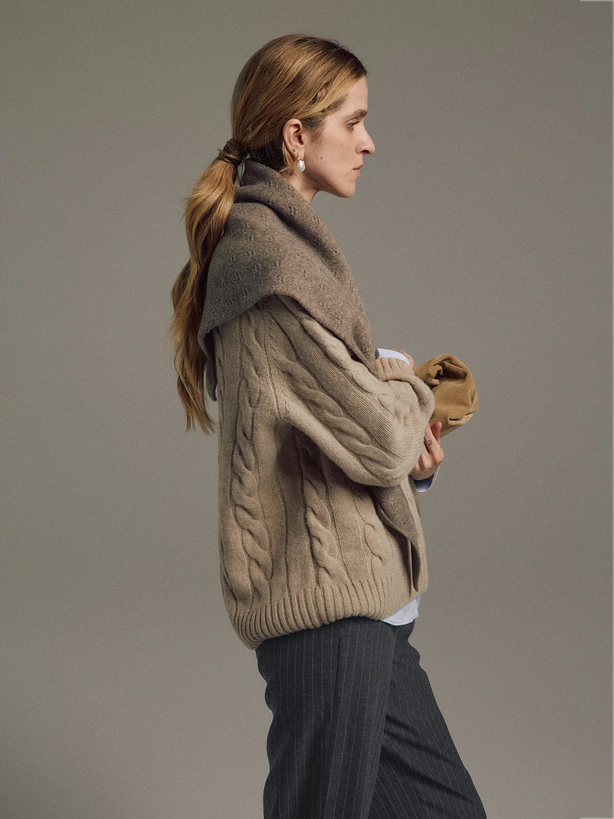 Side view of model wearing the taupe yak wool triangle scarf draped over shoulders with a cable-knit sweater.