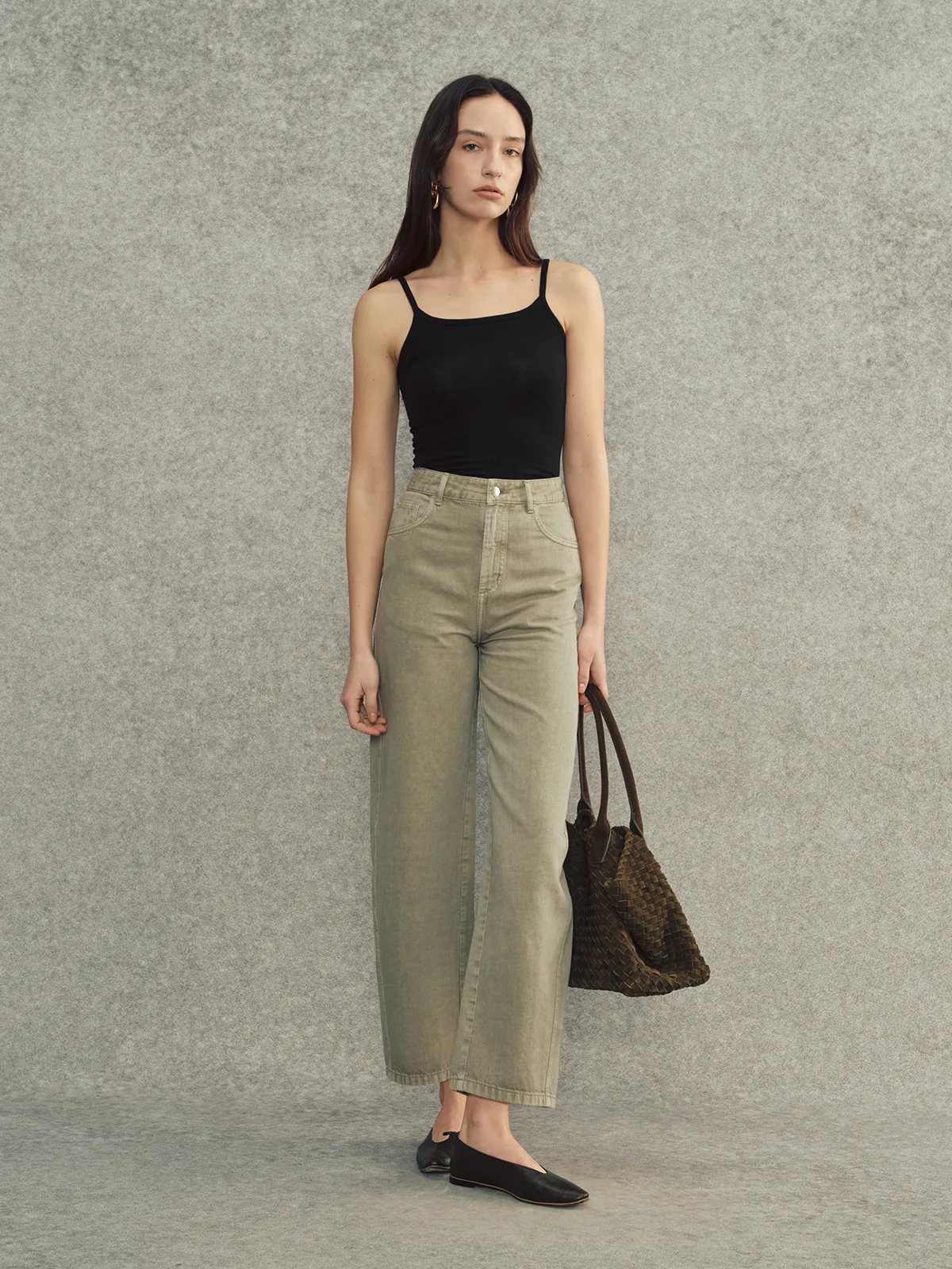 Black LANA camisole with olive green cropped wide-leg jeans and woven leather tote — modern monochrome styling