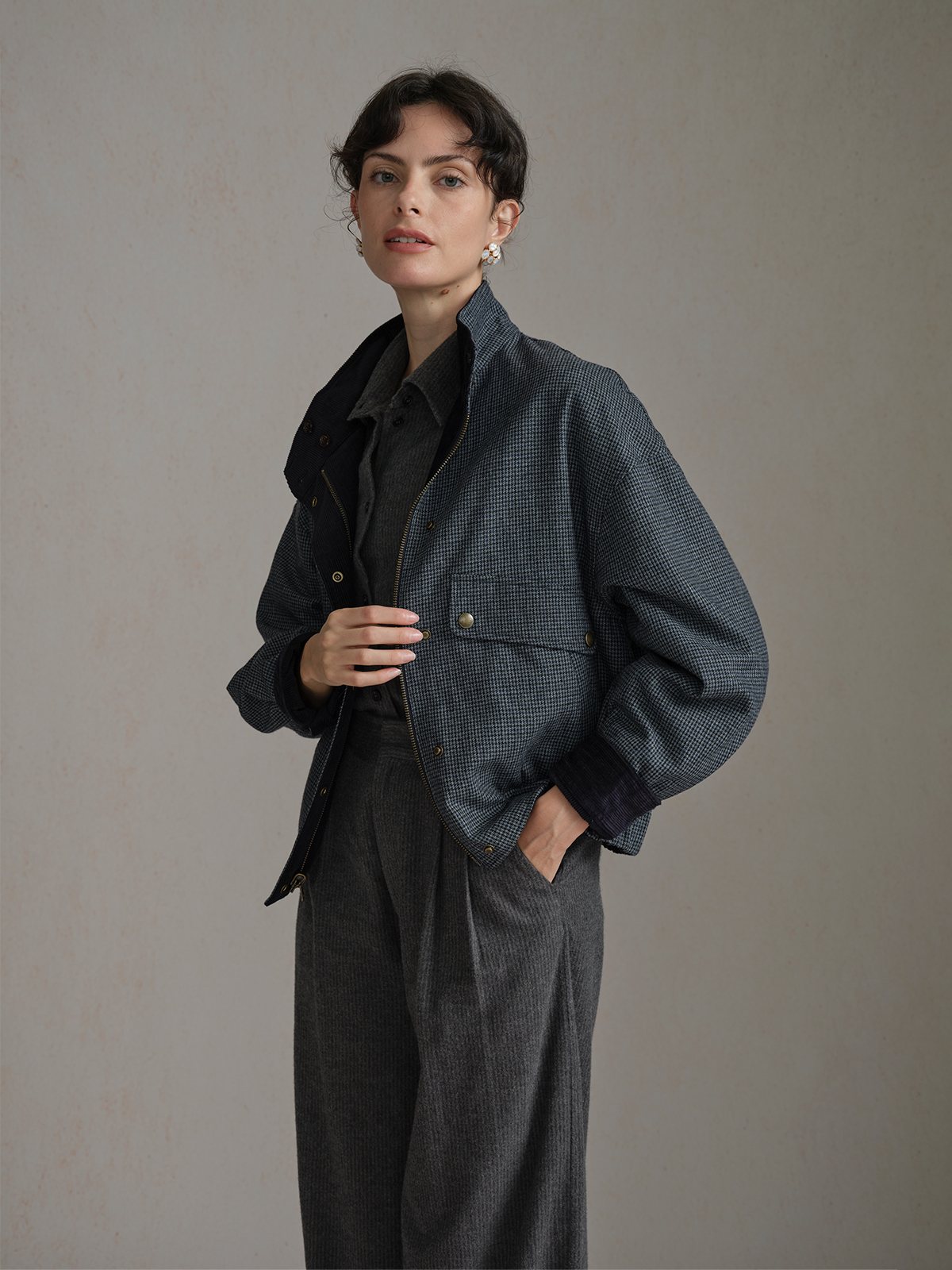 Three-quarter view of the Navy Andreatang CHARLIE houndstooth side with a dark shirt and dark trousers.