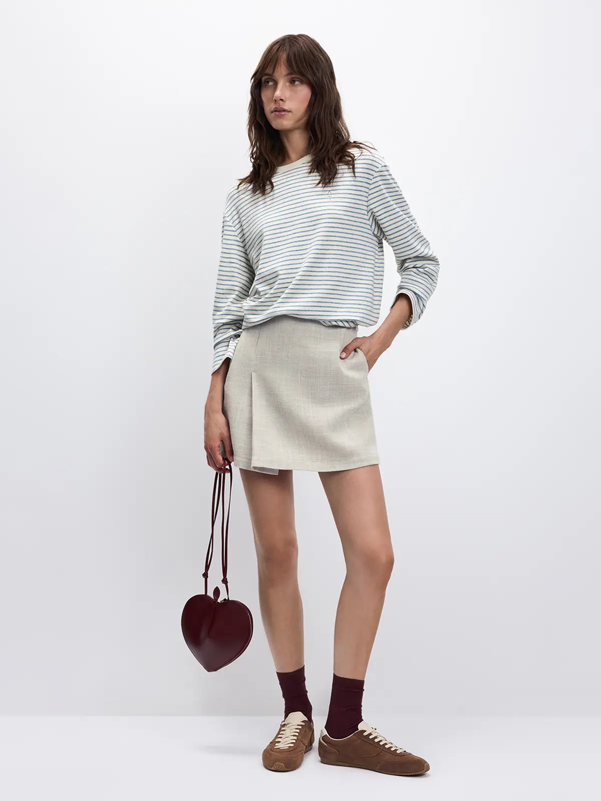 Model standing front-facing wearing a Black/White horizontally striped long-sleeve t-shirt with wide-leg jeans.