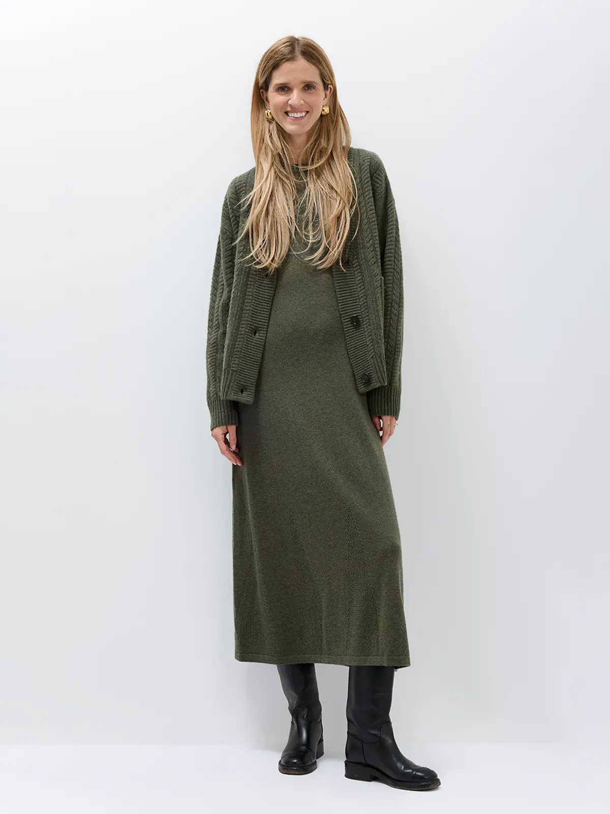 Close-up front view of the long-sleeve knitted dress, highlighting texture and fit.