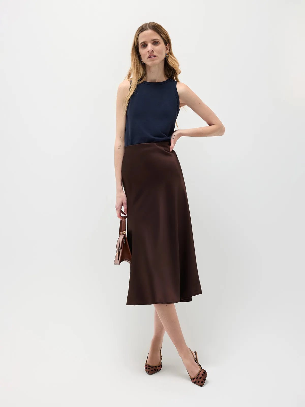 Model wearing navy HOLLY straight fit tank top with chocolate satin midi skirt and leopard-print heels