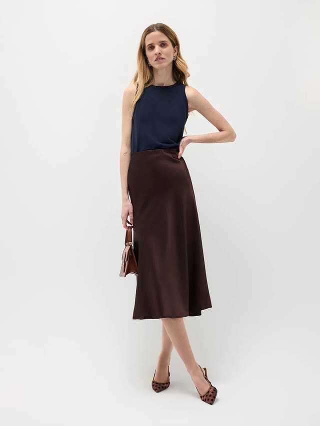 Model wearing navy HOLLY straight fit tank top with chocolate satin midi skirt and leopard-print heels