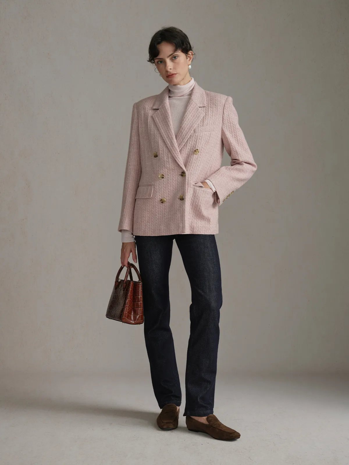 Model wearing dusty pink HARLOW Cable Knit Blazer with white turtleneck, dark denim, and brown croc-embossed bag—full-body front view
