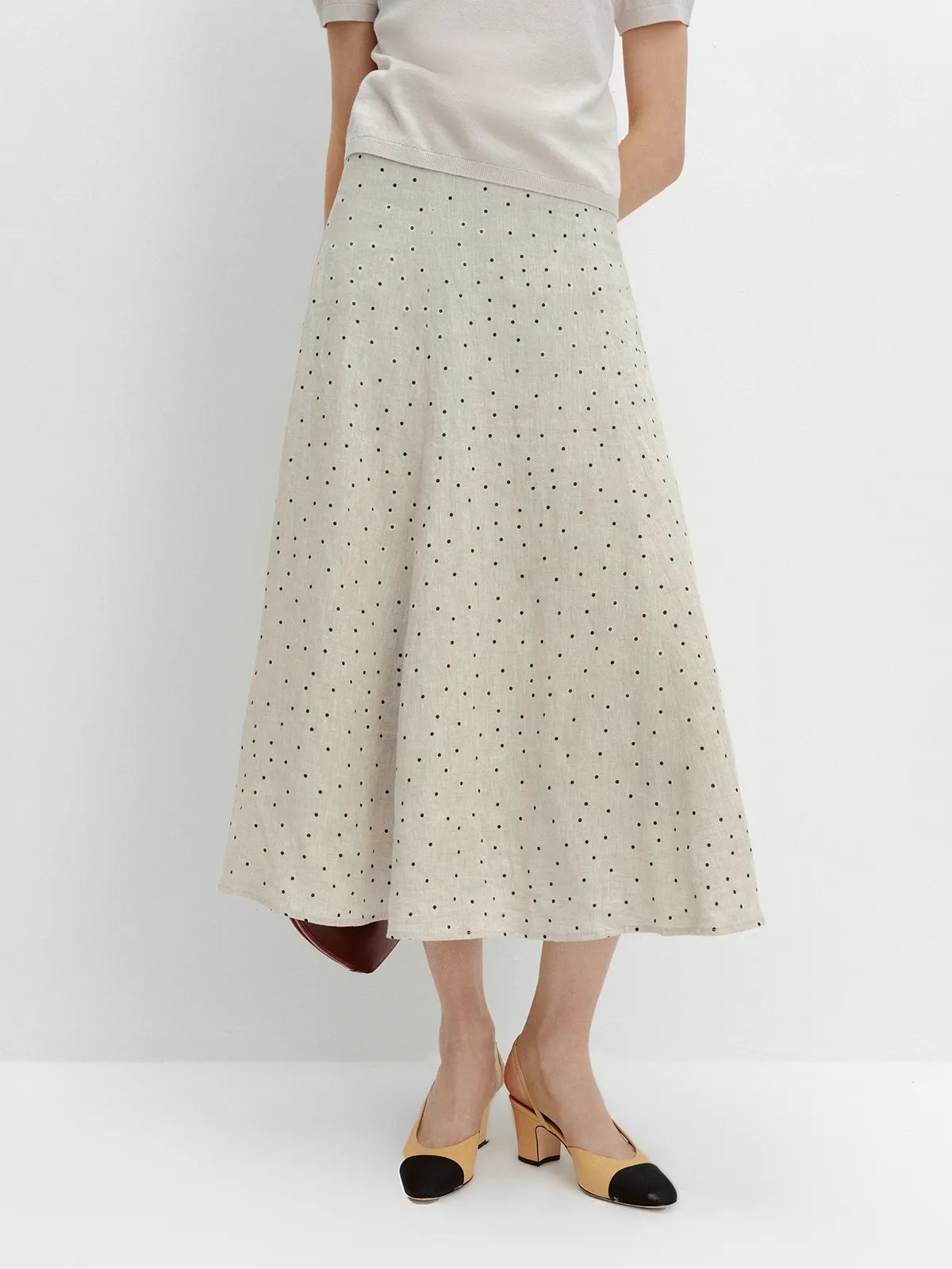 Front view of DOTTIE linen skirt with cream knit top, two-tone heels, slight angle