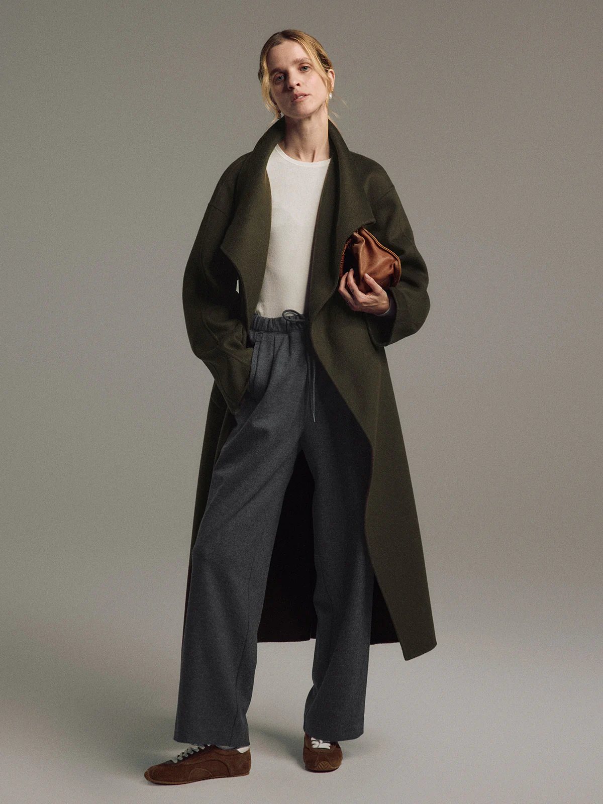 Close-up side view of Dark Gray wool blend trousers showing drawstring waistband and pleats.