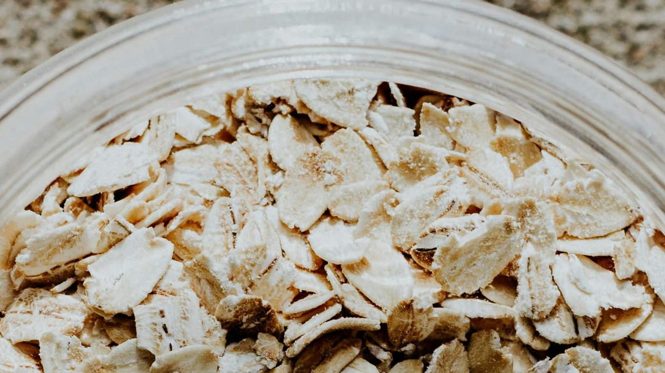 Close-up of rolled oats in a clear glass bowl.