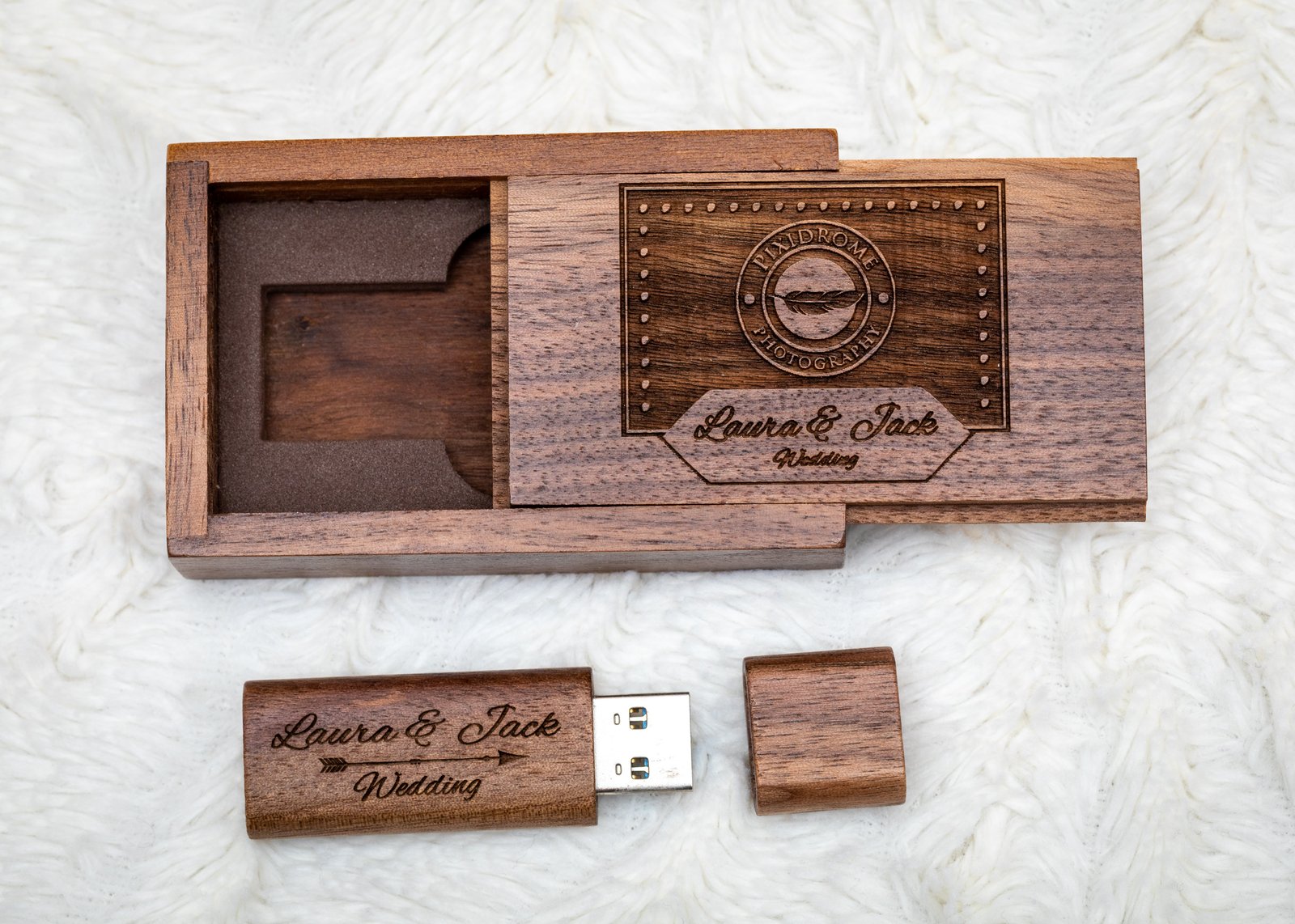 Personalised wooden USB drive engraved with the couple&rsquo;s names, beside its matching engraved wooden gift box.