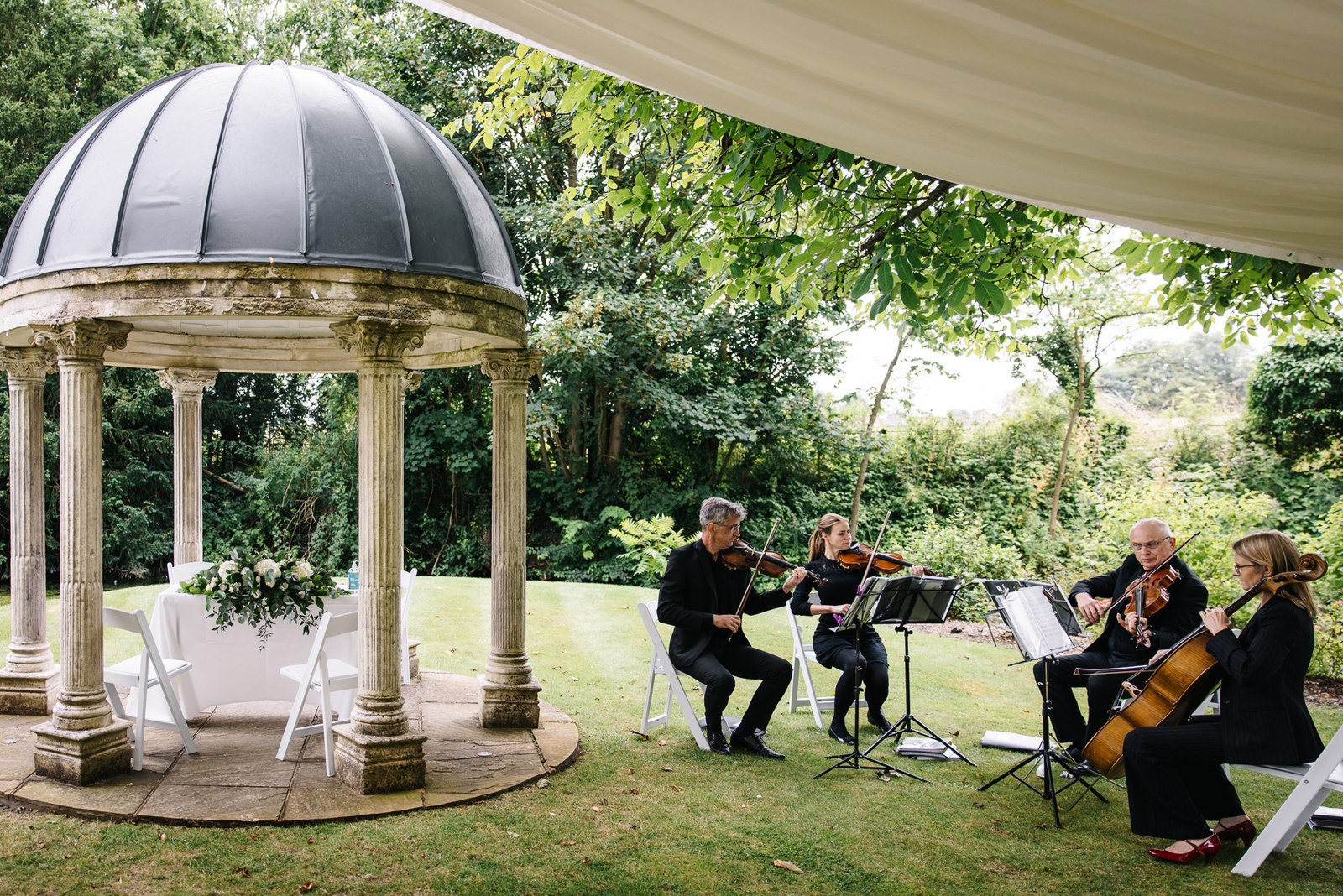 The domed stone temple in the gardens of Ardington House where a string quartet plays