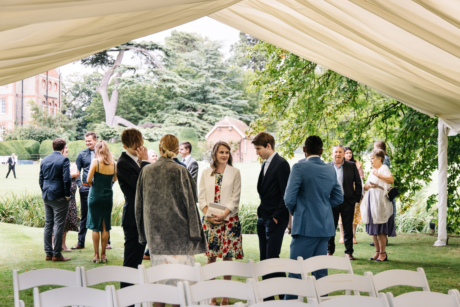 Guests gathered and chatting under the marquee ahead of the ceremony