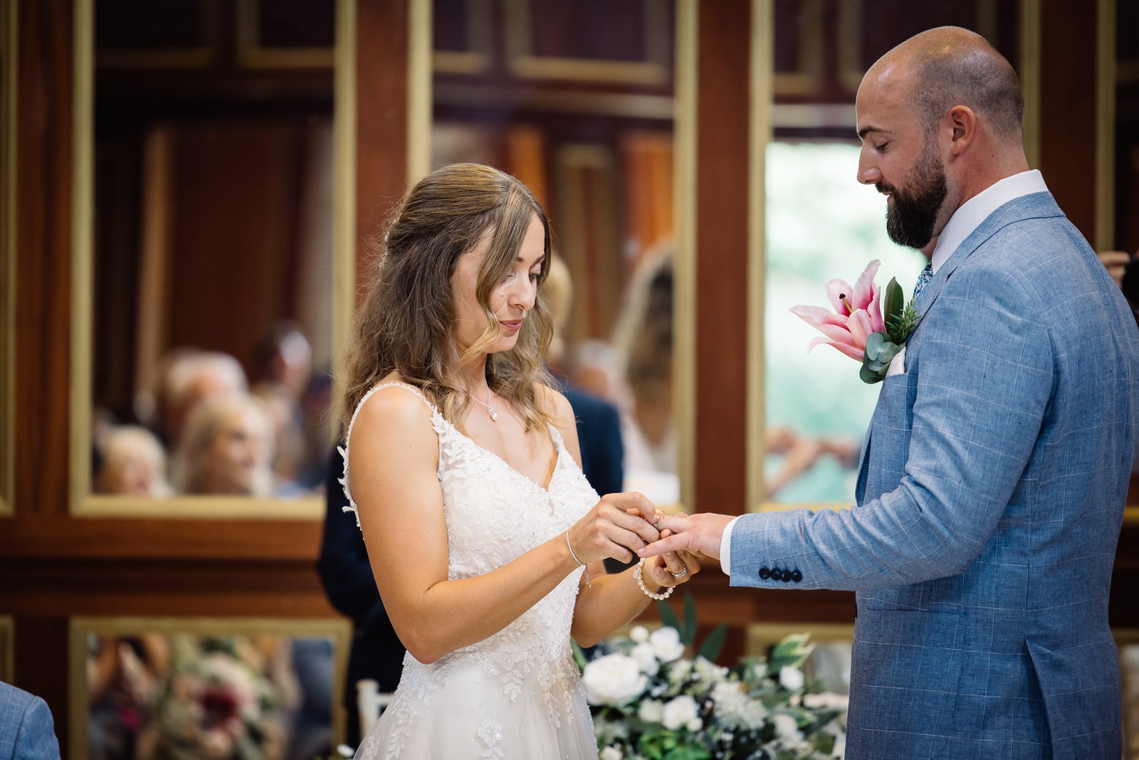 The bride placing the ring on the groom's finger during the ceremony