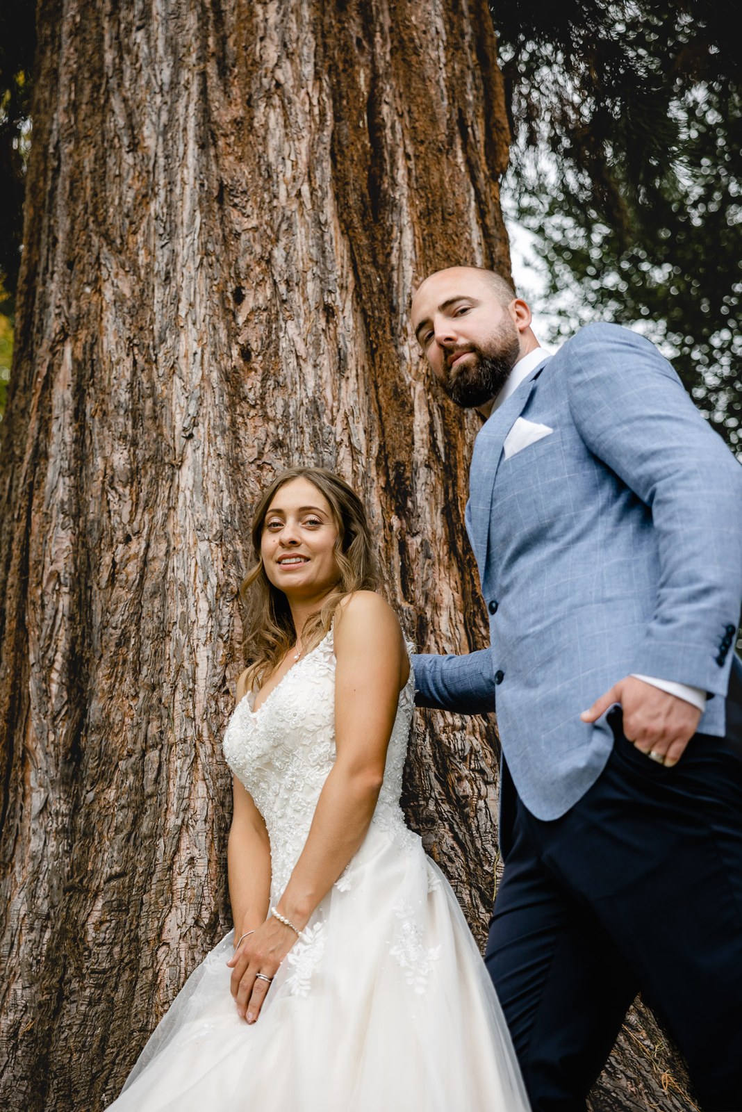 The couple posing against the vast trunk of a redwood in the grounds of Bourton Hall