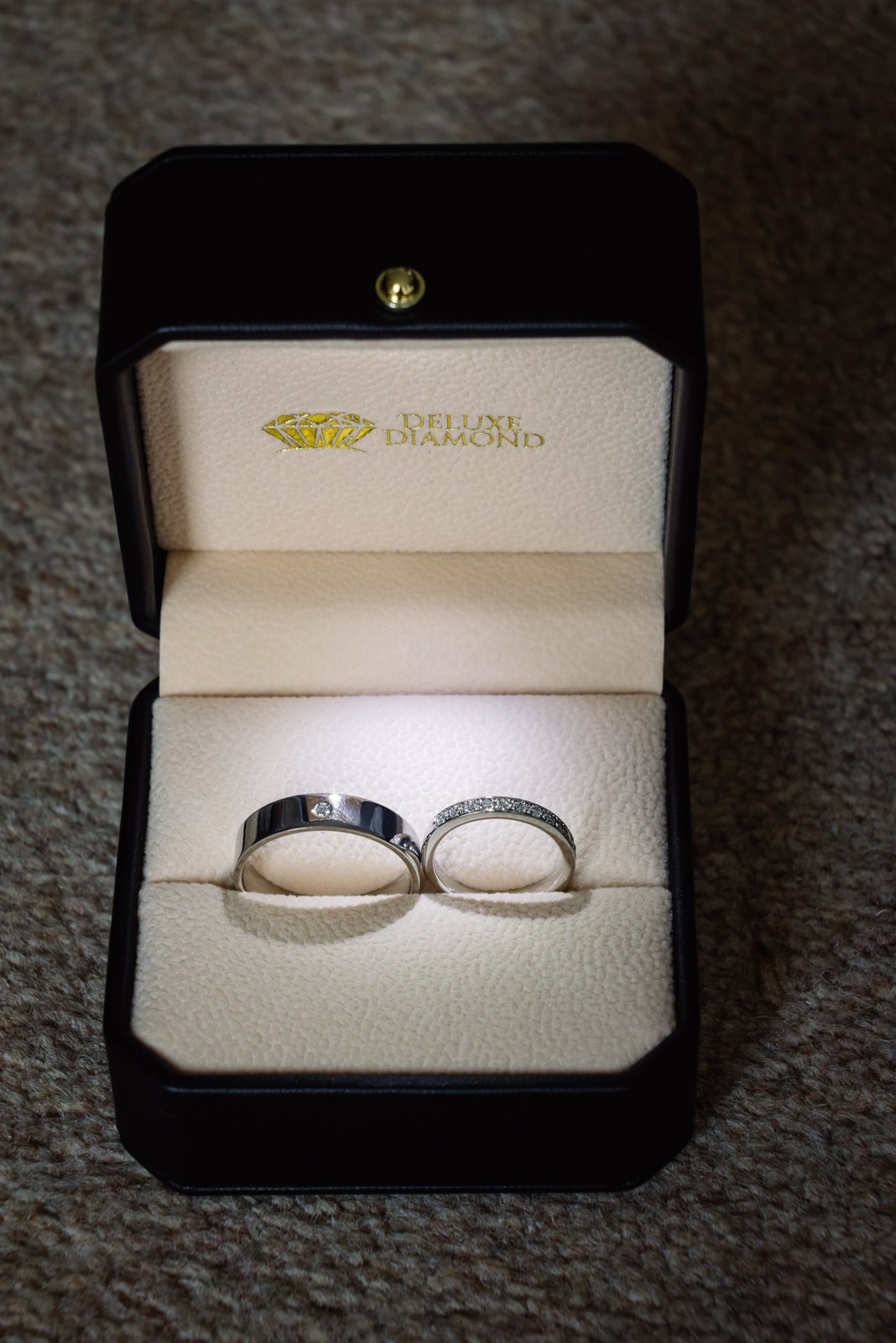 Two wedding rings resting in a presentation box