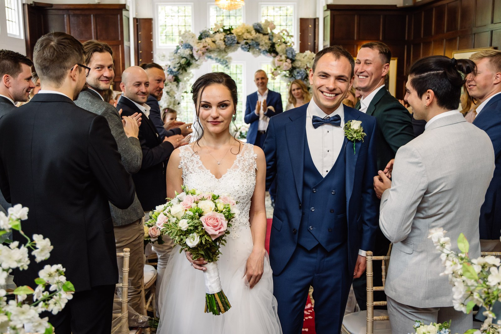 The newlyweds walking back down the aisle greeting their guests