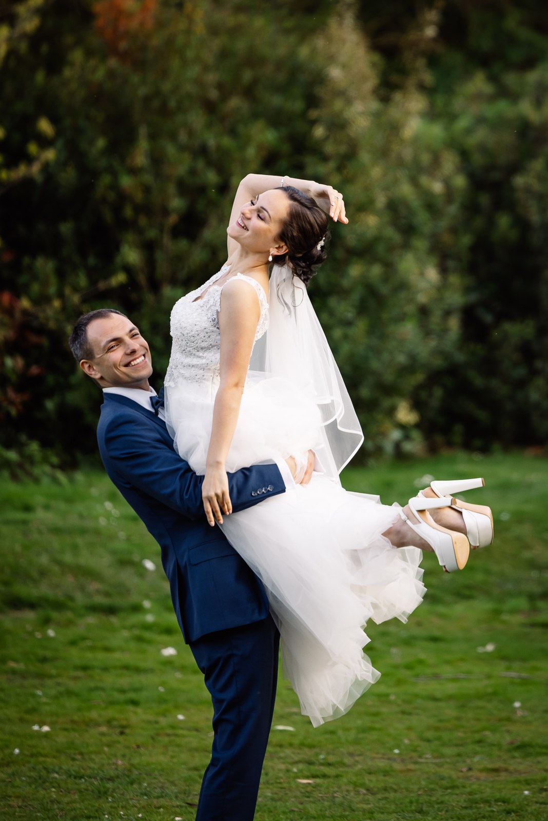 The groom lifting the bride in his arms in the garden at Cantley House Hotel