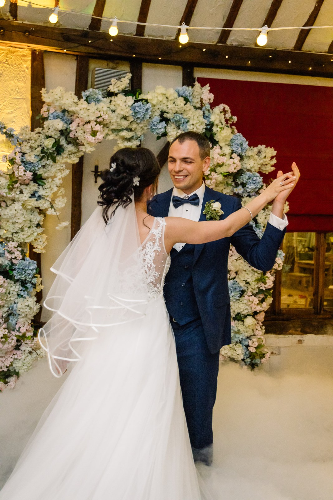 The couple's first dance beneath the floral arch at Cantley House Hotel