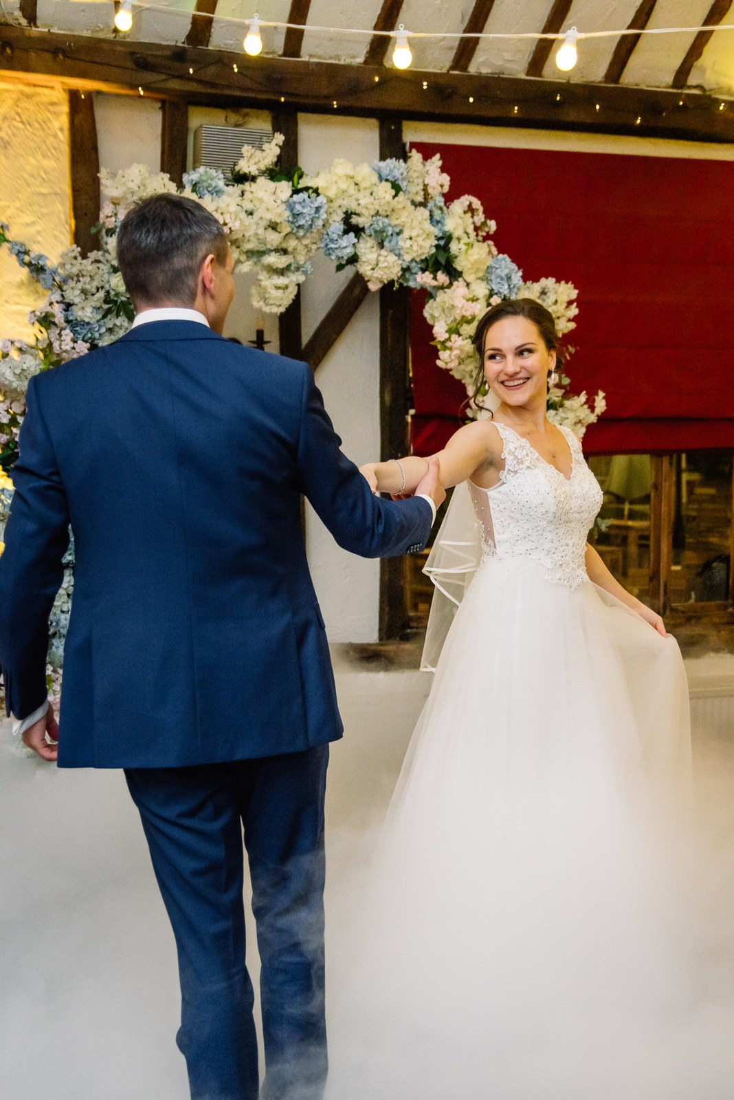 The groom leading the bride in their first dance
