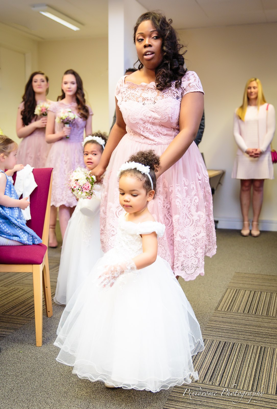 Bridesmaids and flower girls processing into the ceremony room