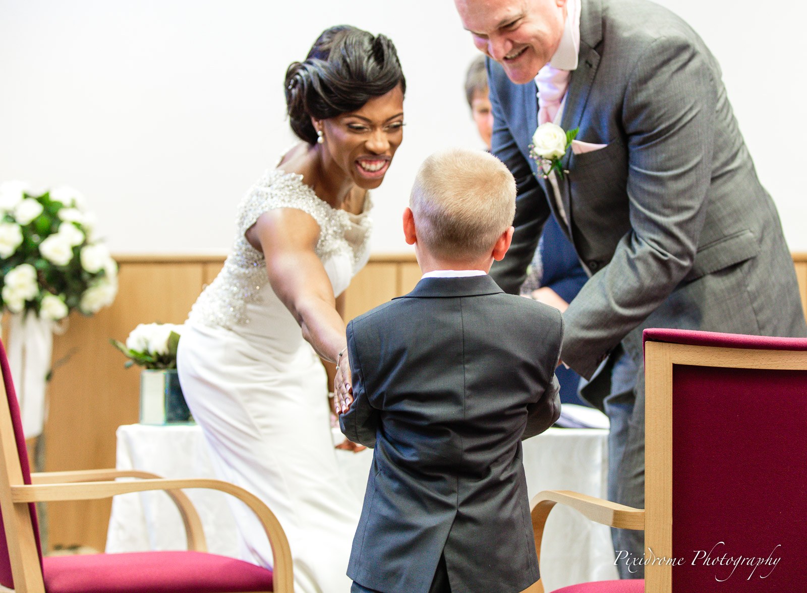 The couple greeting the page boy bringing the rings