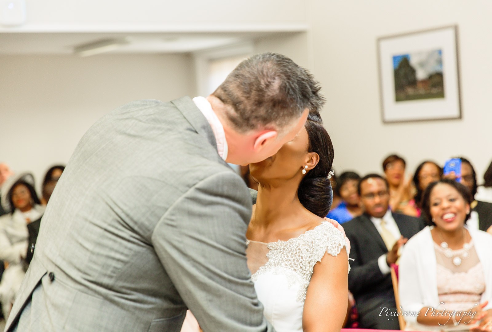 The couple's first kiss as guests laugh and cheer