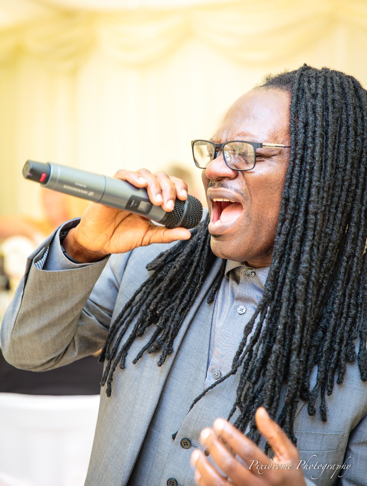 A vocalist performing into the microphone at the reception