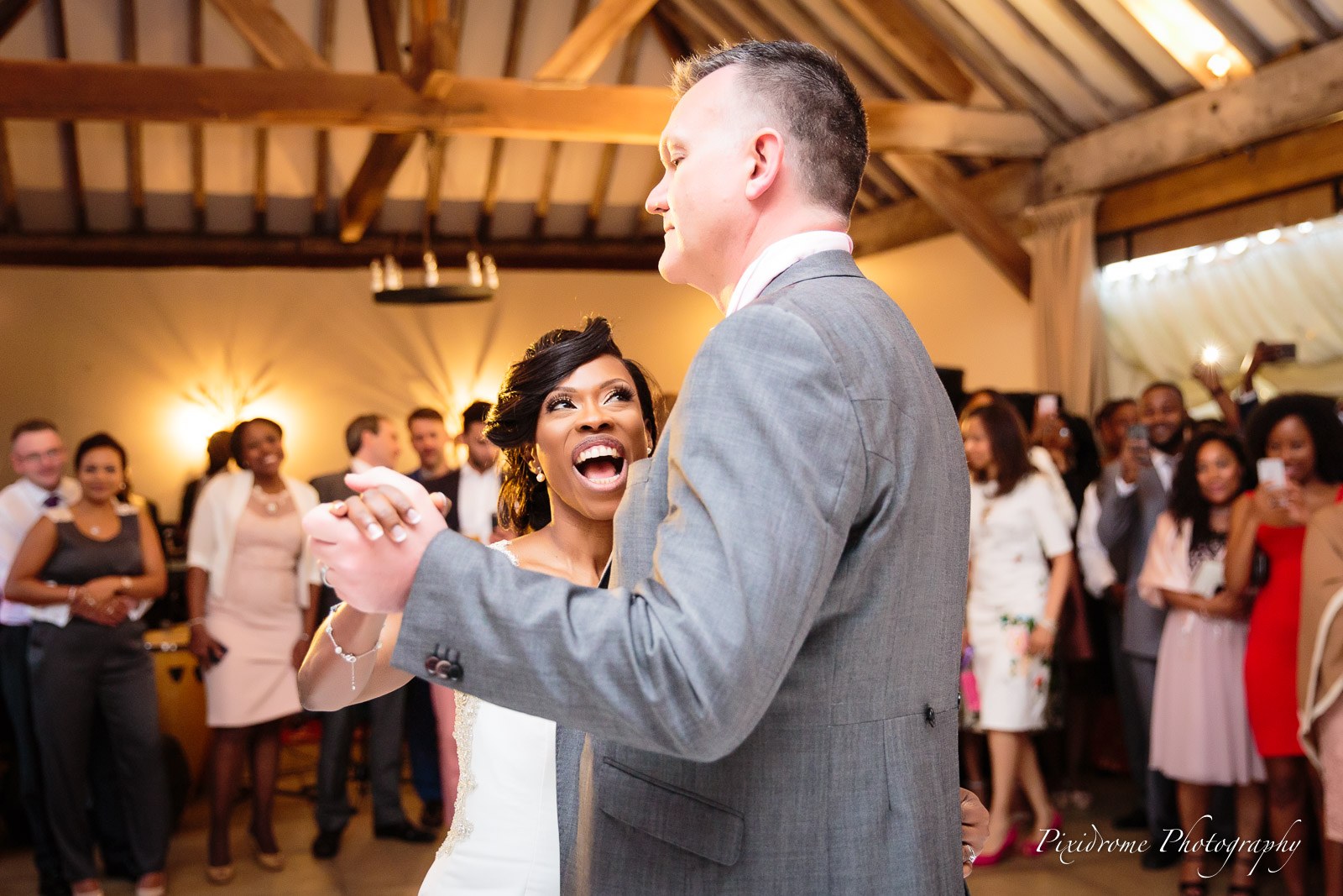 The couple's first dance in the beamed reception hall at Chenies Manor House