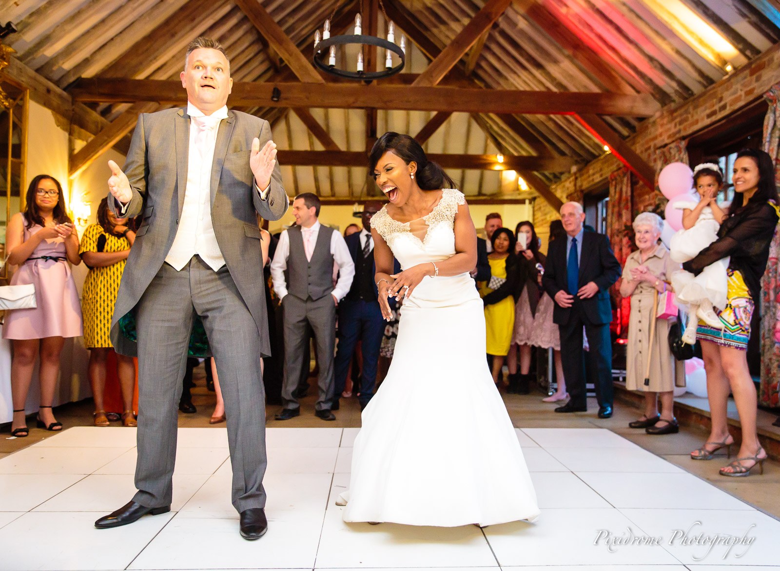 The groom singing and dancing beside the bride among the guests