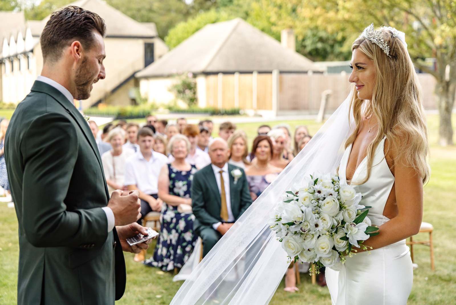 Bride and groom facing each other at the open-air ceremony