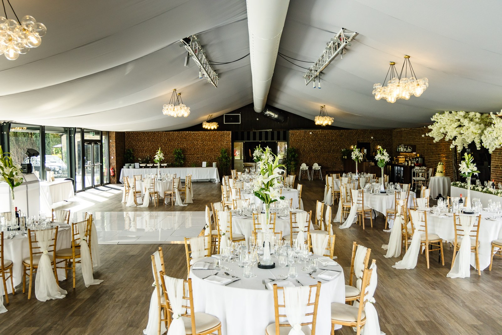 The reception room at the Chesterton Hotel with round tables beneath a draped ceiling