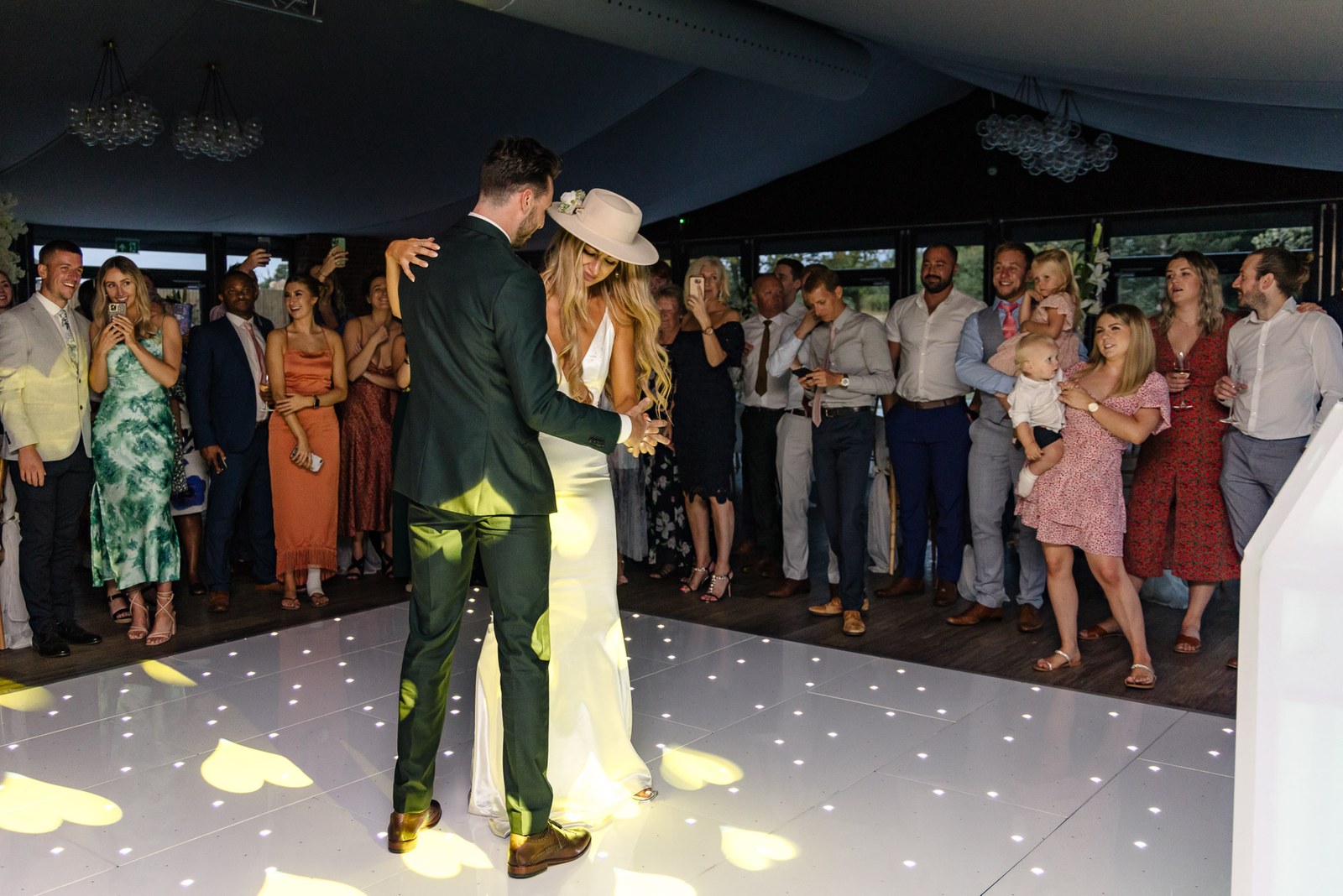 The couple's first dance watched by guests on the starlit floor
