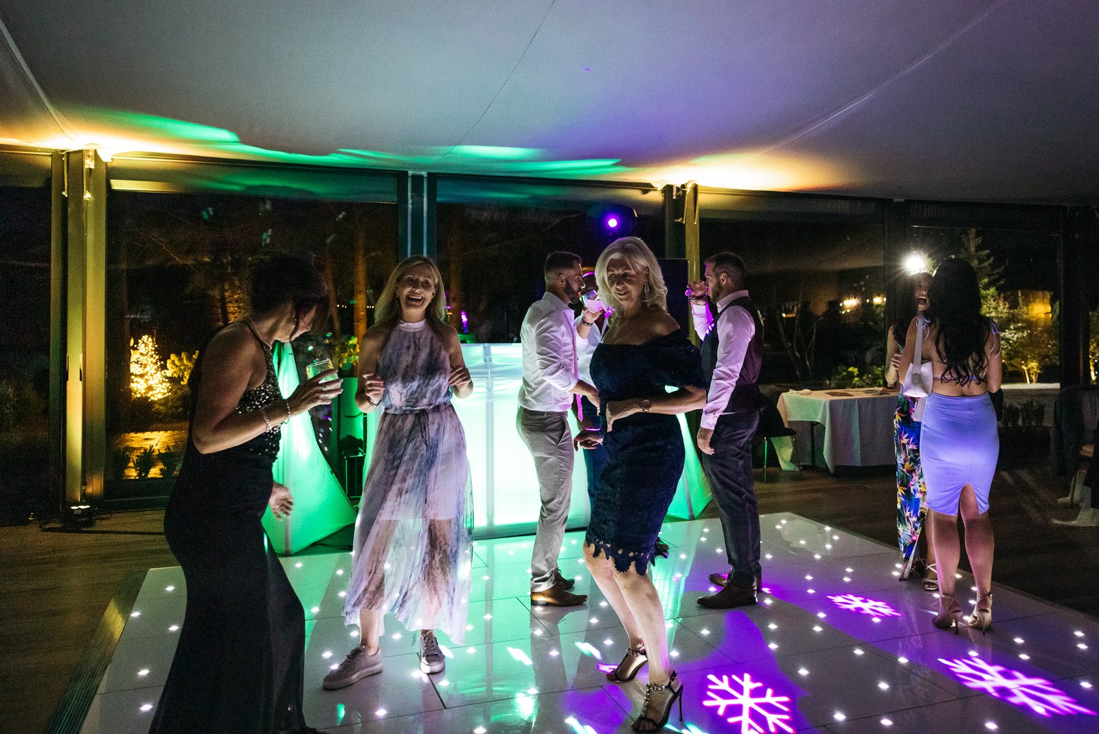 Guests dancing under snowflake gobos and disco lighting
