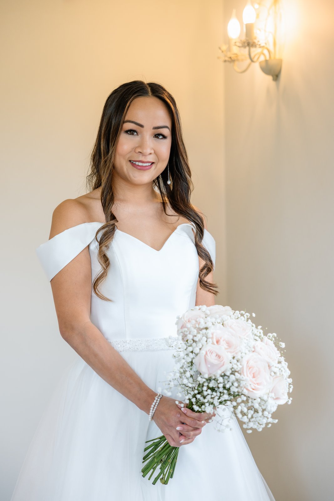 The bride holding her bouquet in the getting ready room at Cider Mill Barns