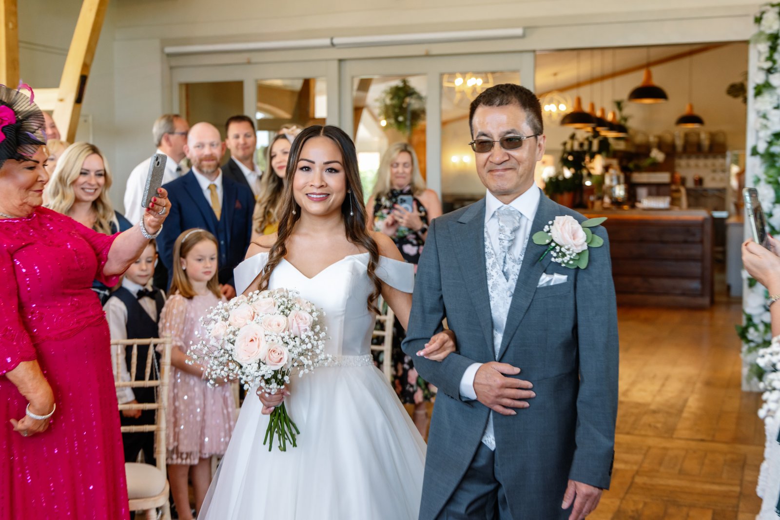 The bride walking down the aisle on her father's arm