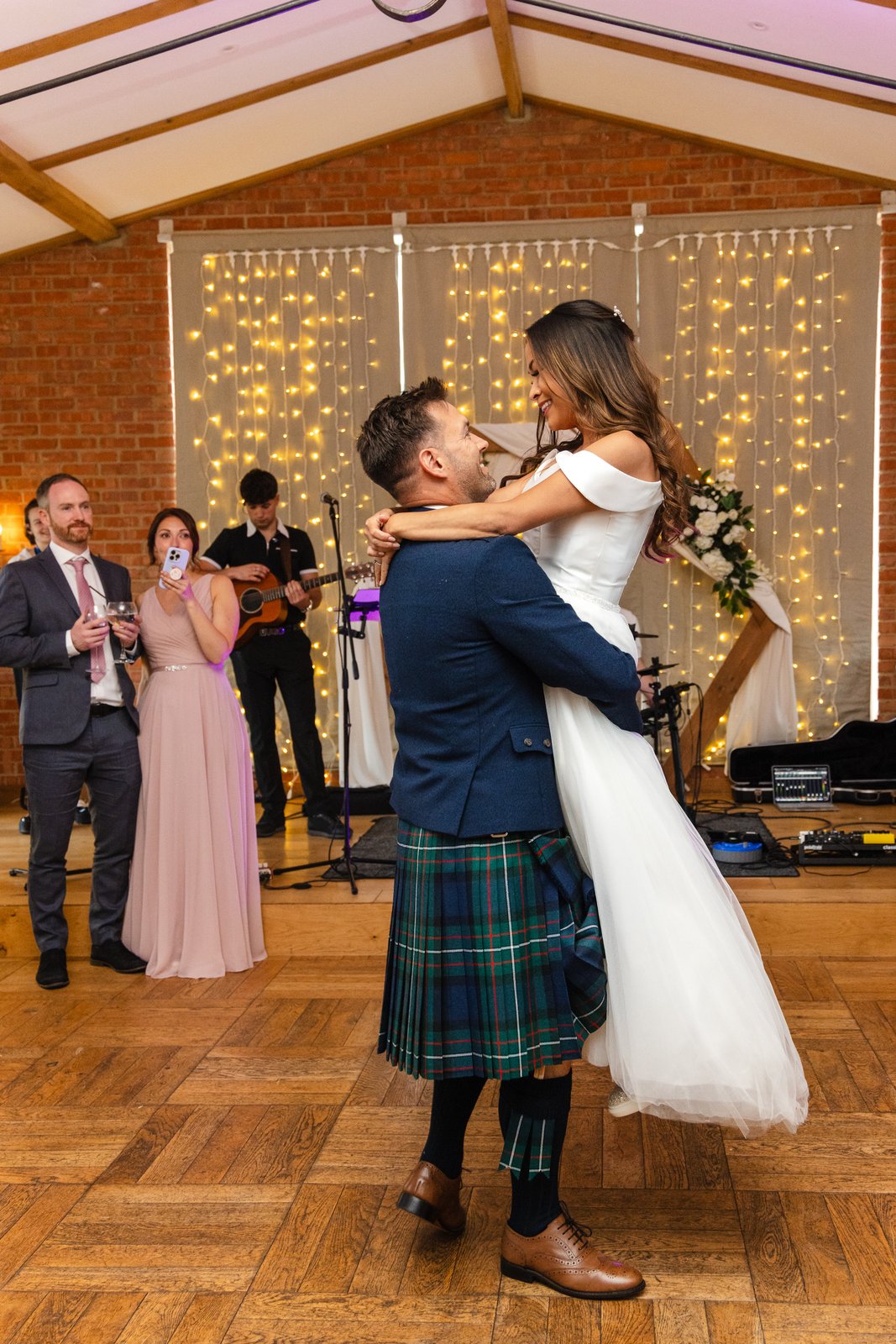 The groom lifting the bride off the floor during the first dance