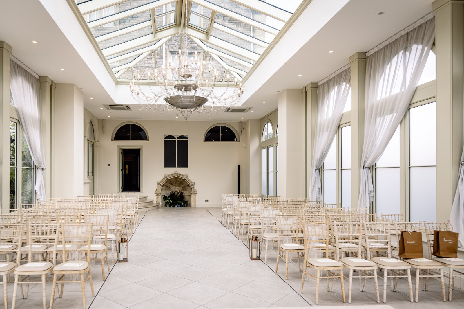 The glass-roofed orangery at Clevedon Hall set with chairs for the ceremony