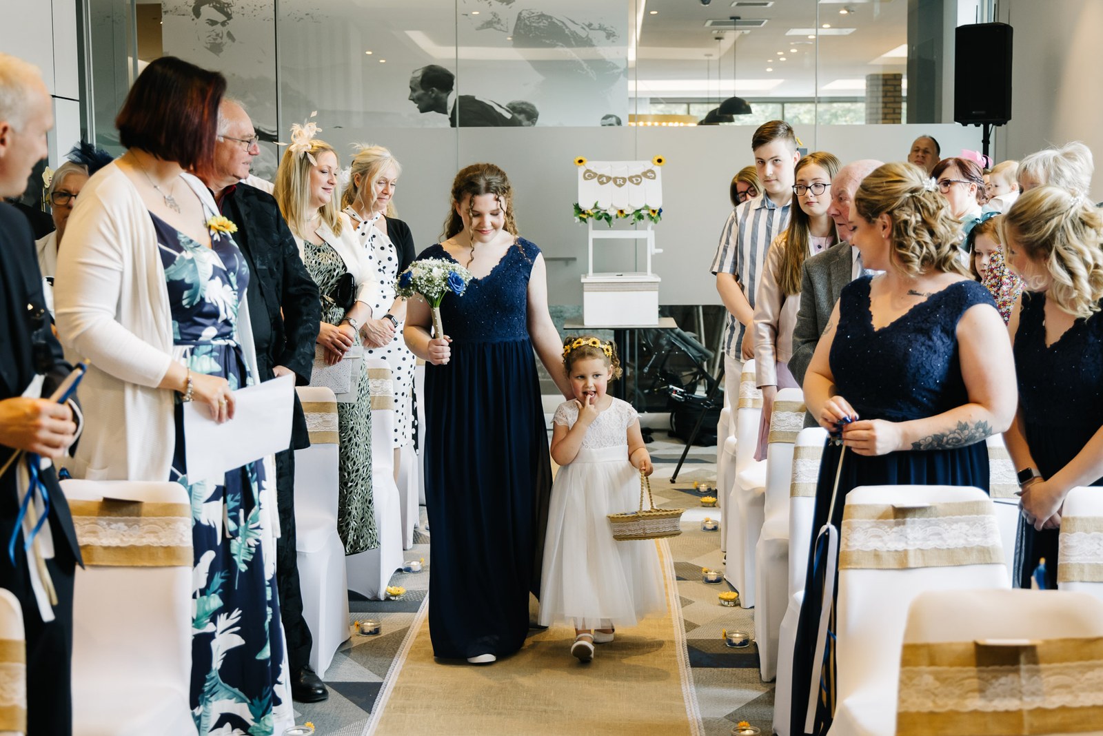 Guests and a flower girl gathered in the ceremony room at Courtyard by Marriott Oxford South